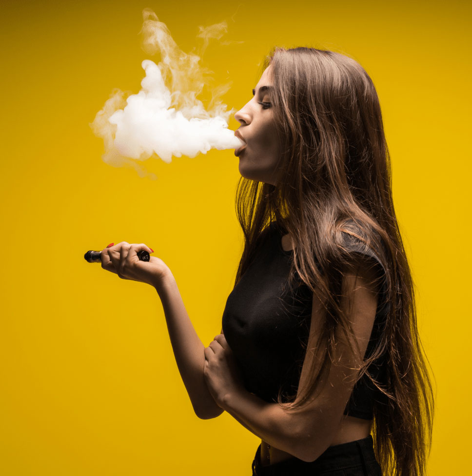 Woman vaping on yellow background